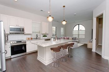 a kitchen and living room with white cabinets and a white counter top at Fairfax, Ohio, 43212